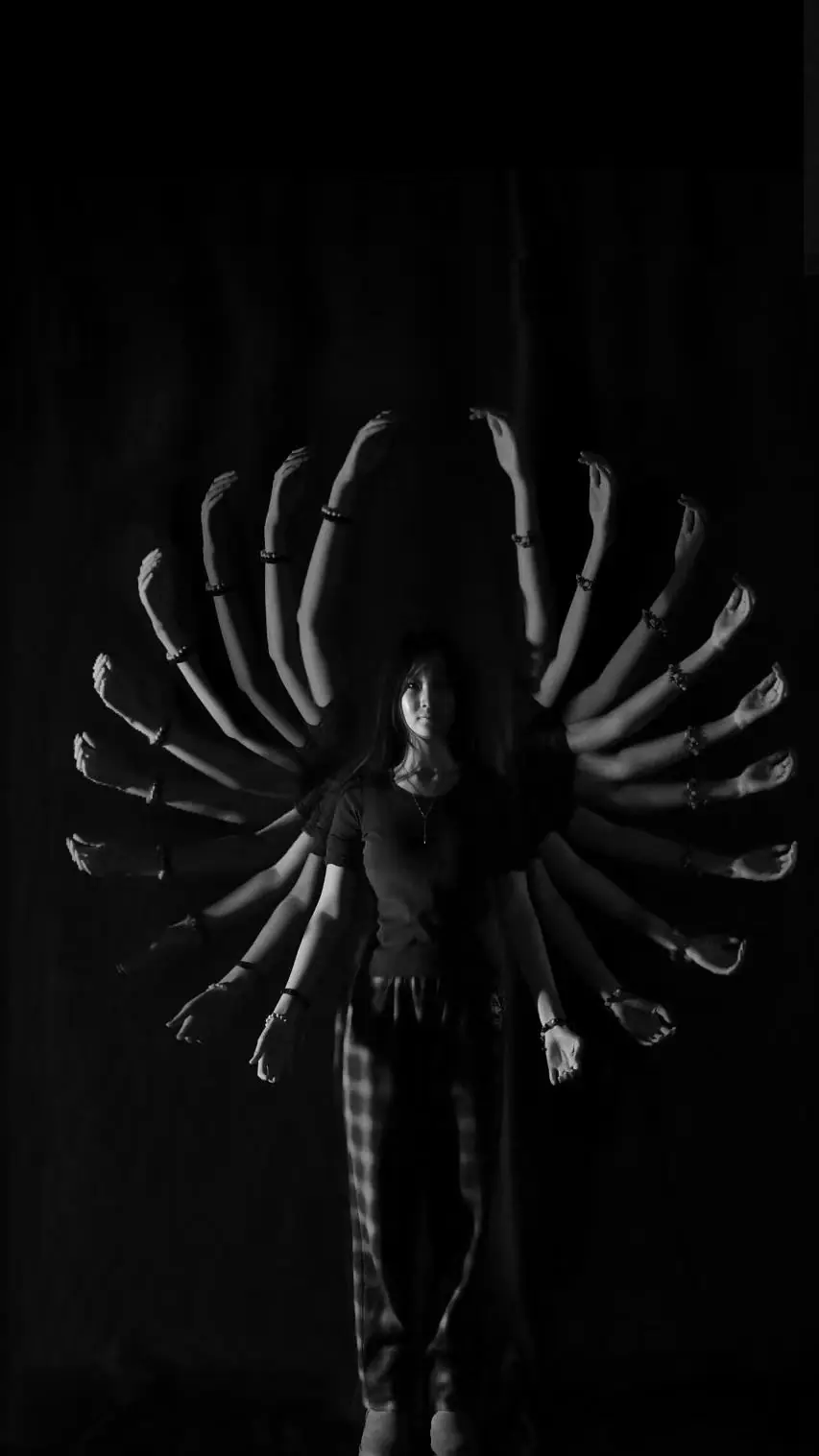 Light-painting photograph of a figure with radiating arms