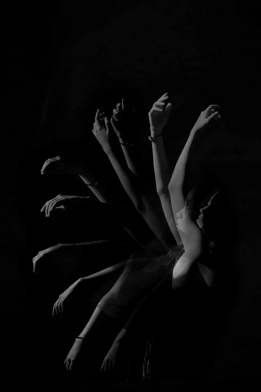Light trails drawn by moving hands in the dark