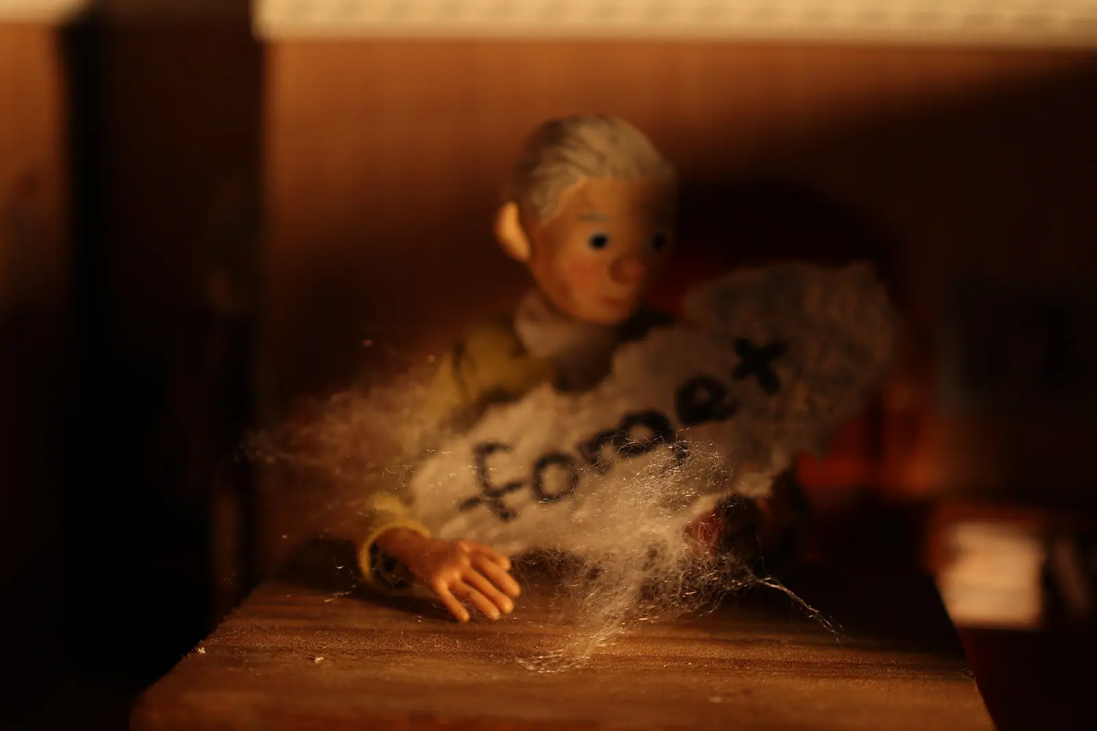 Stop-motion puppet of a grandfather surrounded by fog
